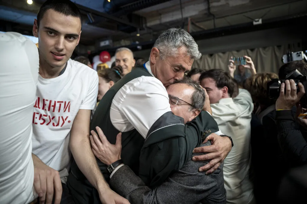 Ilija Srdanovic celebrates with supporters at Student List headquarters in Belgrade