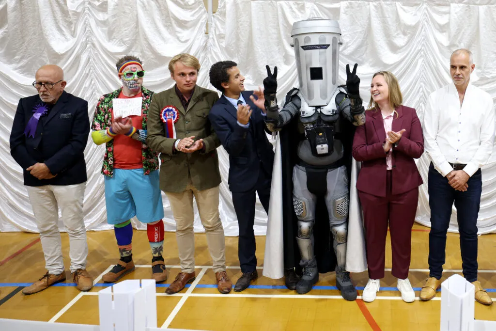 Count Binface and other candidates wait for the Clacton winner to be declared — the spectacle underlines how voters used the ballot to mock Westminster